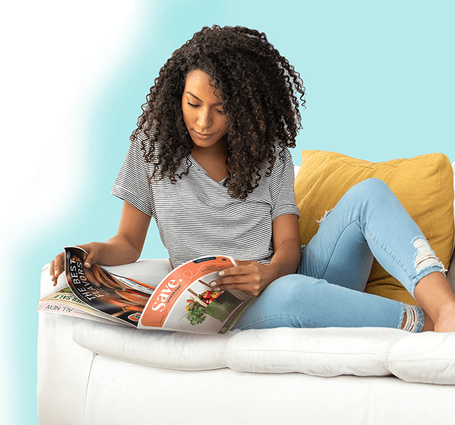 Woman on couch reading magazine